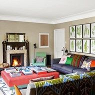 a living room filled with furniture and a fire place in the middle of the room