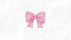 a pink bow with words on it sitting on top of a piece of white paper