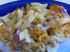 a blue plate topped with pasta and meat