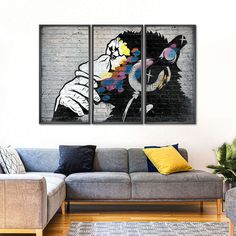 a living room with two paintings on the wall and a couch in front of it