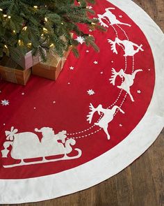 a red and white christmas rug with santa's sleigh on it