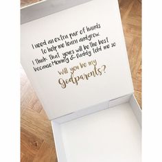 an open white box with gold lettering on the inside that says, will you be my grandparents?