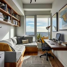 a living room filled with furniture next to a window covered in bookshelves and windows