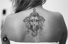 the back of a woman's shoulder with an elephant tattoo design on her chest