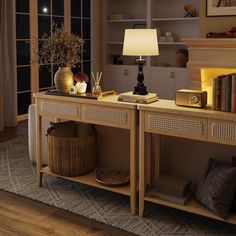 a living room filled with furniture and a fire place next to a lamp on top of a table