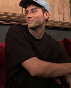 a man sitting on top of a red couch