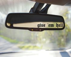 a rear view mirror with the words give'em hell written in black on it