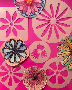 paper flowers and circles on a pink surface