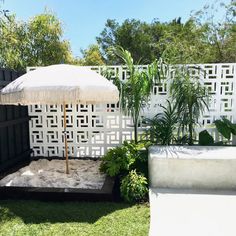 an umbrella sitting in the middle of a yard