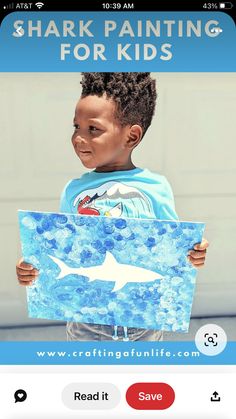 a young boy holding up a shark painting for kids on the app store's website