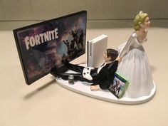 a figurine sitting on top of a desk next to a computer monitor and keyboard