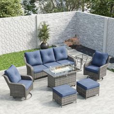 an outdoor patio furniture set with blue cushions