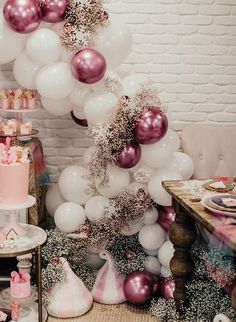 a party with balloons, cake and decorations