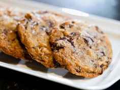 three chocolate chip cookies on a white plate