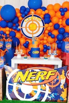 an orange and blue themed party with balloons