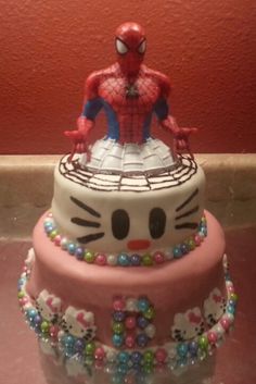 a hello kitty cake with a spiderman on top