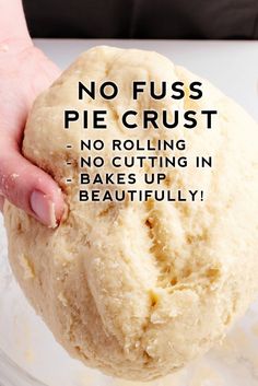 a person holding a ball of dough in their hand with the words no fuss pie crust on it