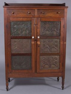 an old wooden cabinet with metal inserts on the doors and drawer drawers, inlaid with flowers