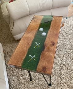 a coffee table with golf balls and tees on it in front of a couch