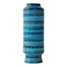 a tall blue vase with intricate designs on it's sides and the bottom part of its body