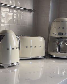 two toasters sitting next to each other on a counter