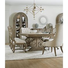 a dining room table with chairs and a chandelier