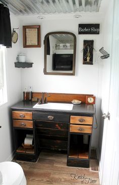 a bathroom with a sink, mirror and other items on the counter top in it