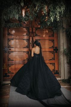 the back of a woman's dress in front of a wooden door