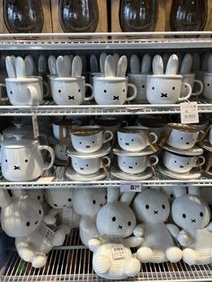 the shelves are filled with many different kinds of mugs and bunny ears on them