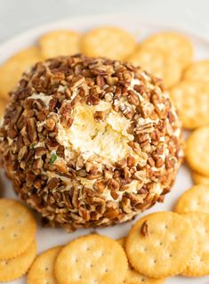 a cheese ball on a plate surrounded by crackers