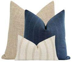 two blue and beige pillows sitting next to each other