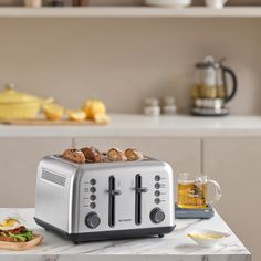 a toaster sitting on top of a kitchen counter next to a plate of food