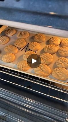 cookies baking in an oven with the word m on it's bottom right hand corner