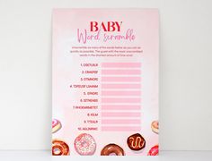 a baby shower game with doughnuts on the side and words in pink above it