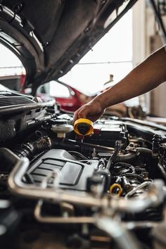 a man working on an engine in a car