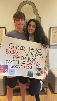 two people holding a sign that says sophia, we are bound 2 co - to - from together so make this easy by saying yes