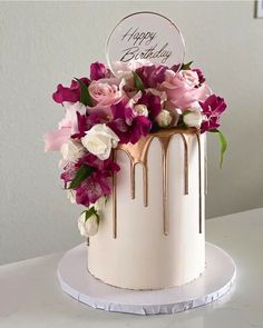 a birthday cake decorated with flowers and icing