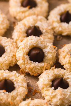 coconut bites with chocolate are arranged on a baking sheet