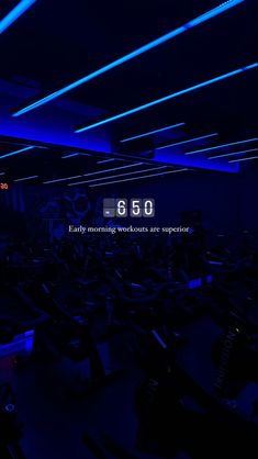 there are many exercise bikes in the gym with blue lights on them and an advertisement that says, 60 early morning workout suggestions