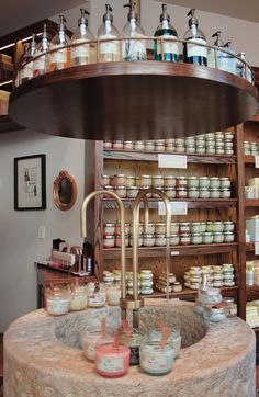 the shelves are filled with many different types of jars and containers on display in a store