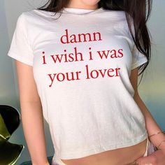 Damn I Wish I Was Your Lover Baby Tee, Aesthetic Baby Tee, Women's Fitted Tee, Unisex Shirt, Trendy Top, Y2K 90s Baby Tee DETAILS - 100% cotton (fiber content may vary for different colors) - tear-away label  SIZING Please find the size chart in the listing photo before purchasing. PLEASE NOTE: Our Baby tee is sized for a youth, reminiscent of the '90s-era shrunken-down T-shirt. This style, popularized by the skater/raver culture of the time, is not to be confused with the modern crop top. The baby tee was the equivalent of a kids' size medium or large and reflected the child-inspired fashion trend of that era. I suggest taking a tee or singlet you already enjoy wearing and measuring it to compare with the dimensions provided size chart in the listing photo, in order to find the ideal size Cute Text Print Top For Streetwear, Cute Slogan Tops For Streetwear, Retro White Tops With Letter Print, Cute Funny Text Top For Streetwear, Cute Streetwear Top With Funny Text, Cute Tops With Funny Text For Streetwear, Y2k White Letter Print Tops, White Y2k Tops With Letter Print, Y2k White Top With Letter Print