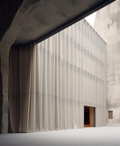 an open door in front of a building with vertical blinds on the outside and inside