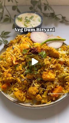 a bowl filled with rice and vegetables on top of a table