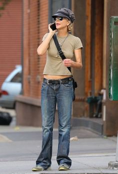 a woman talking on her cell phone while walking down the street