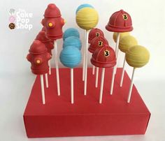 there are many cake pops in the shape of fire hydrants