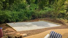 an empty pool in the middle of a wooded area