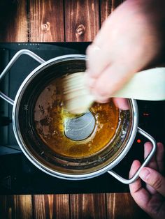 someone is stirring something in a pot on the stove