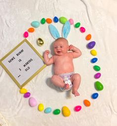 a baby in a diaper is surrounded by candies and an easter sign that says some bunny is 3 months old