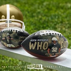 two footballs sitting on top of a metal table with a helmet in the background