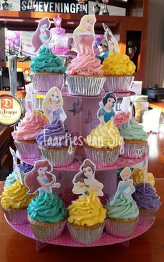 there are many cupcakes in the shape of princesses on top of each other